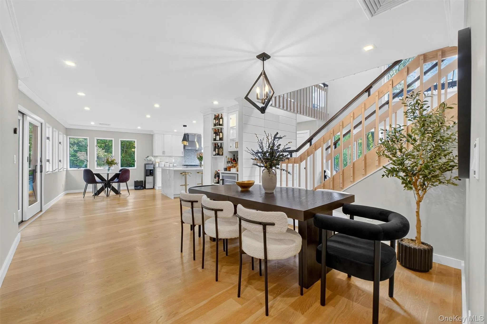 Dining space featuring light wood flooring, recessed lighting, and a chandelier Dining space featuring light wood flooring, recessed lighting, and a chandelier