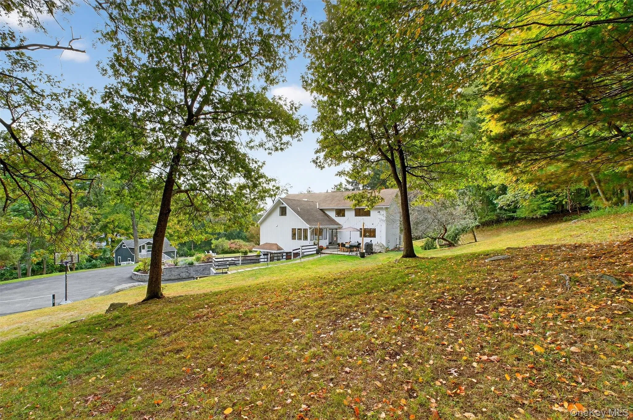 View of green lawn with view of wooded area View of green lawn with view of wooded area