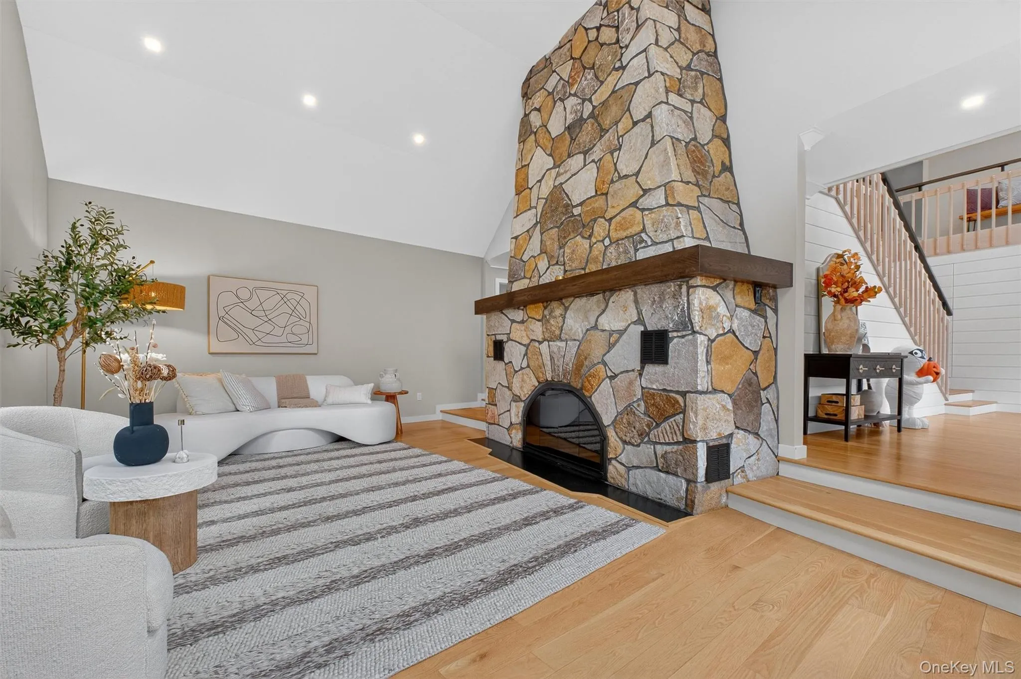 Living room featuring wood  floors, recessed lighting, a fireplace, high vaulted ceiling, lots of light Living room featuring wood  floors, recessed lighting, a fireplace, high vaulted ceiling, lots of light