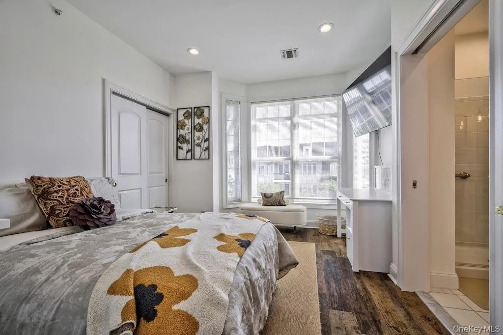 Bedroom featuring dark wood finished floors, a closet, and recessed lighting Bedroom featuring dark wood finished floors, a closet, and recessed lighting