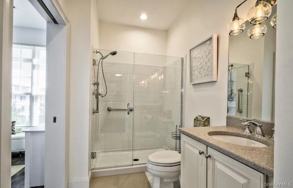Bathroom with vanity and a shower stall Bathroom with vanity and a shower stall