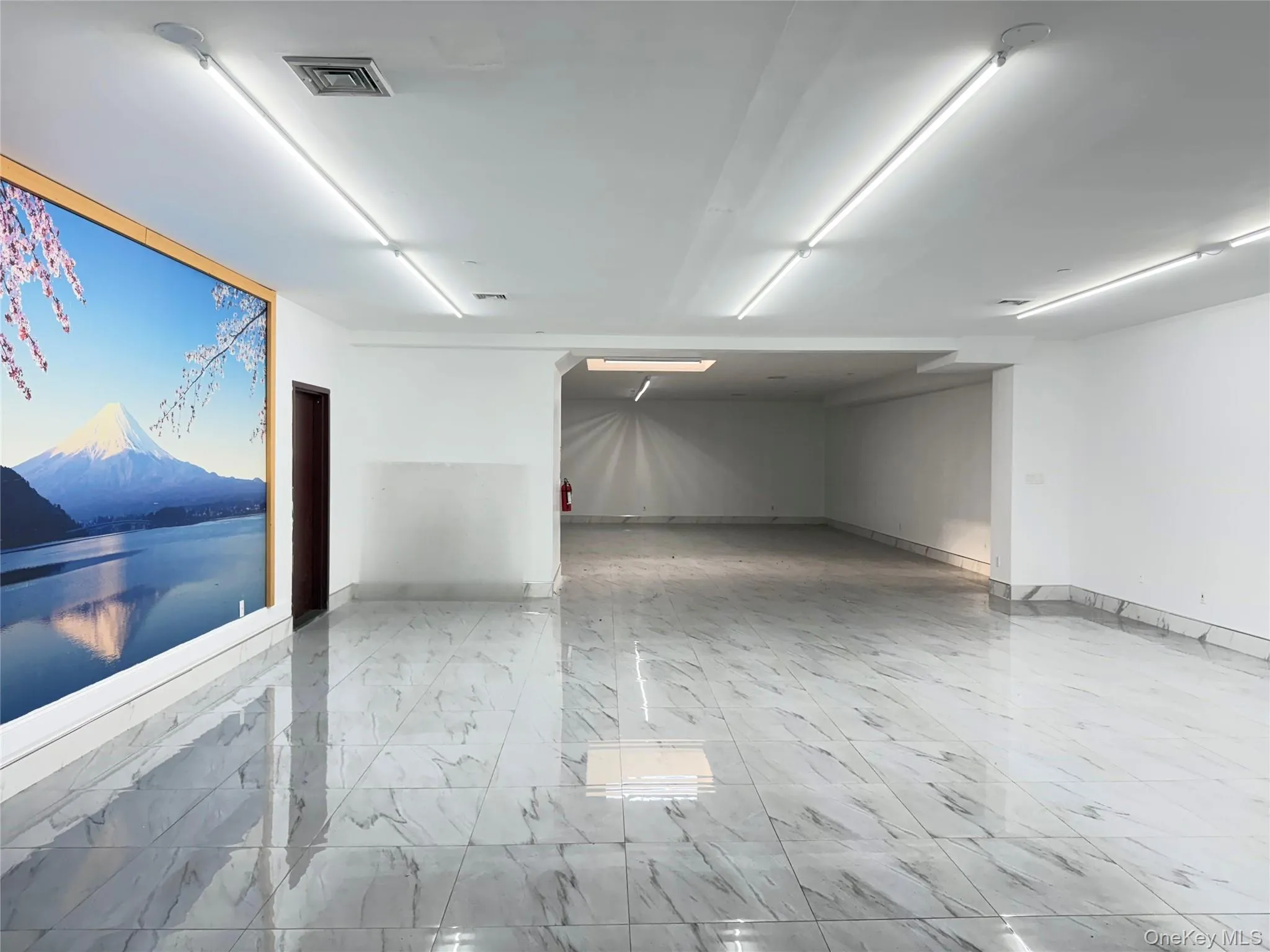 Misc room featuring light marble finish floors and a mountain view Misc room featuring light marble finish floors and a mountain view