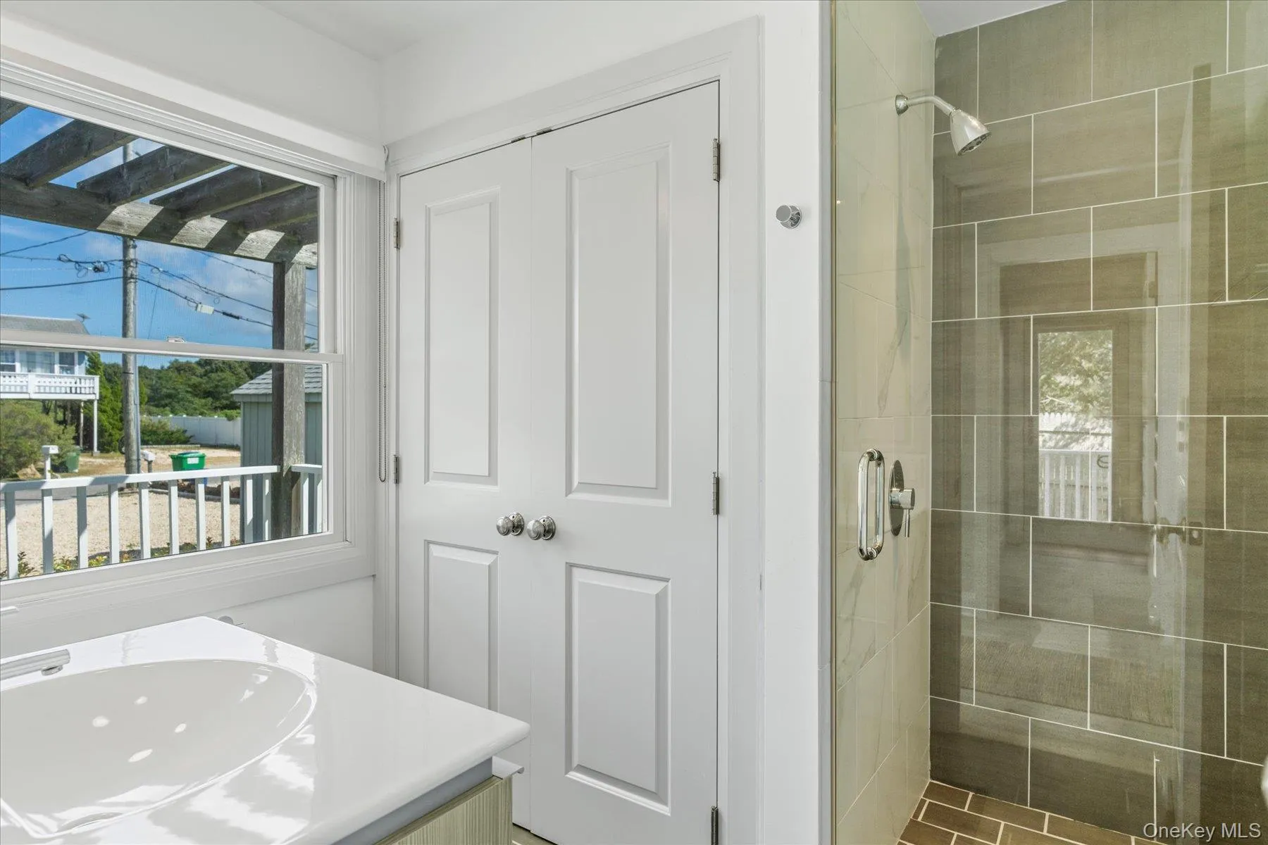 Additional full bathroom conveniently located for guests and access from outdoor shower and beach. Additional full bathroom conveniently located for guests and access from outdoor shower and beach.
