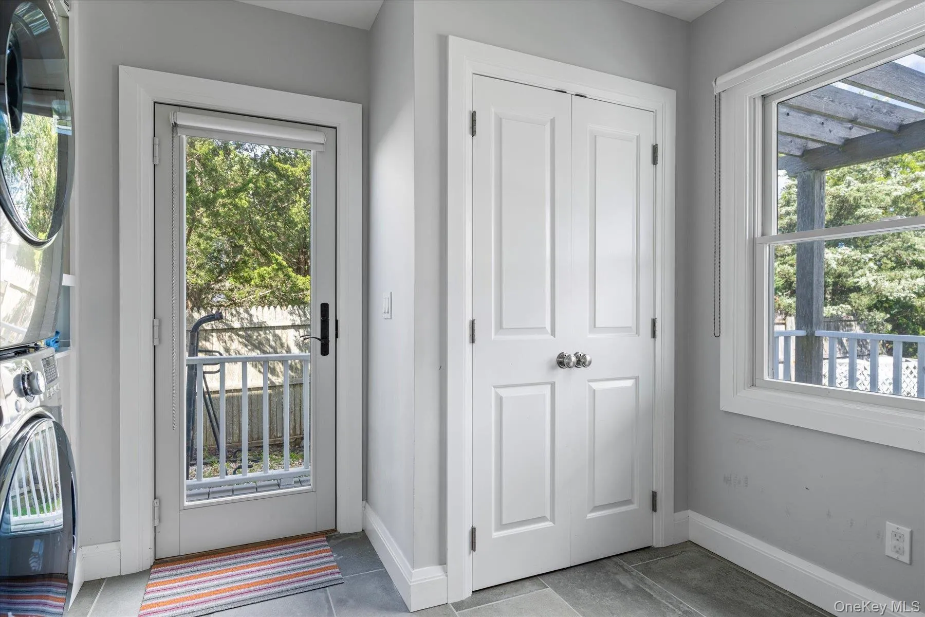 Spacious laundry room with access to outdoor shower. Spacious laundry room with access to outdoor shower.