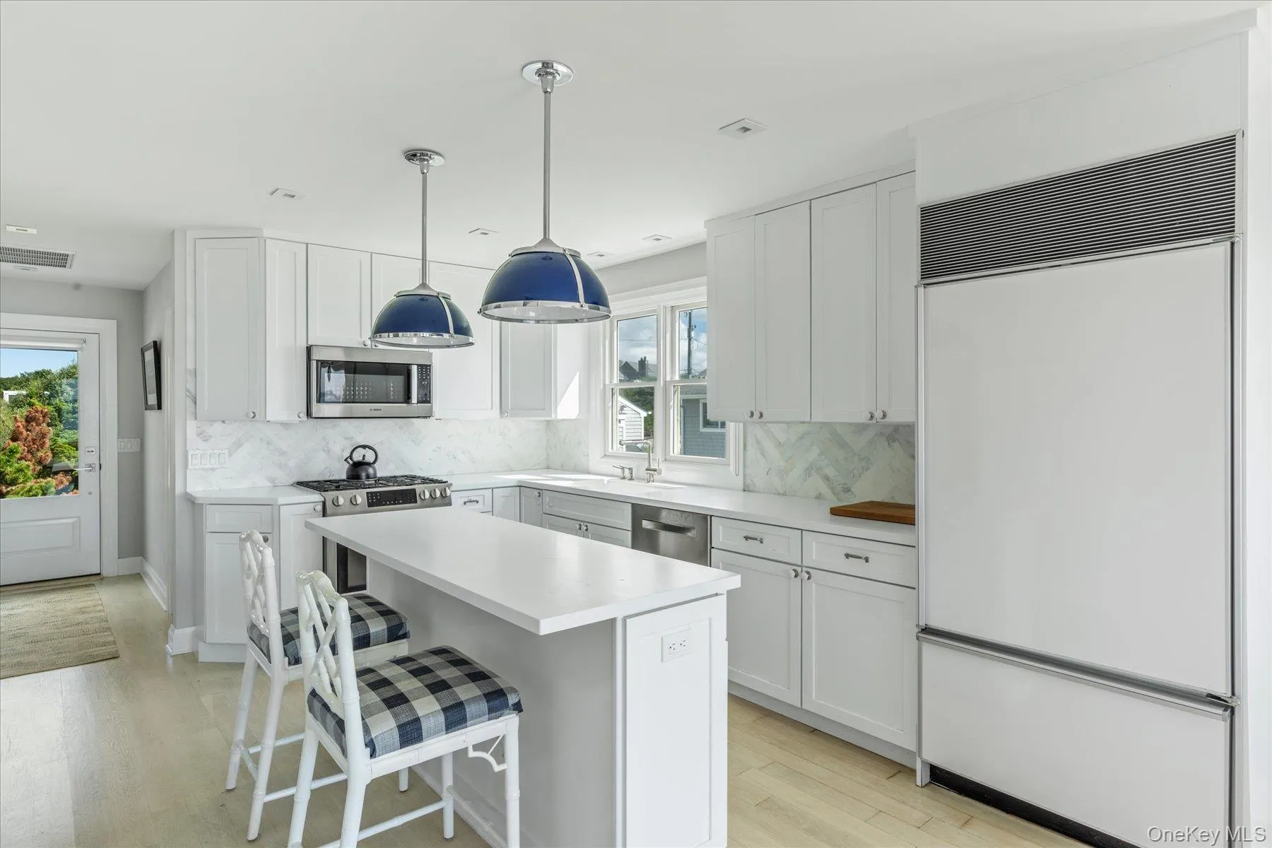Updated custom kitchen with stainless steel appliances, sleek white cabinetry and quartz countertops. Updated custom kitchen with stainless steel appliances, sleek white cabinetry and quartz countertops.