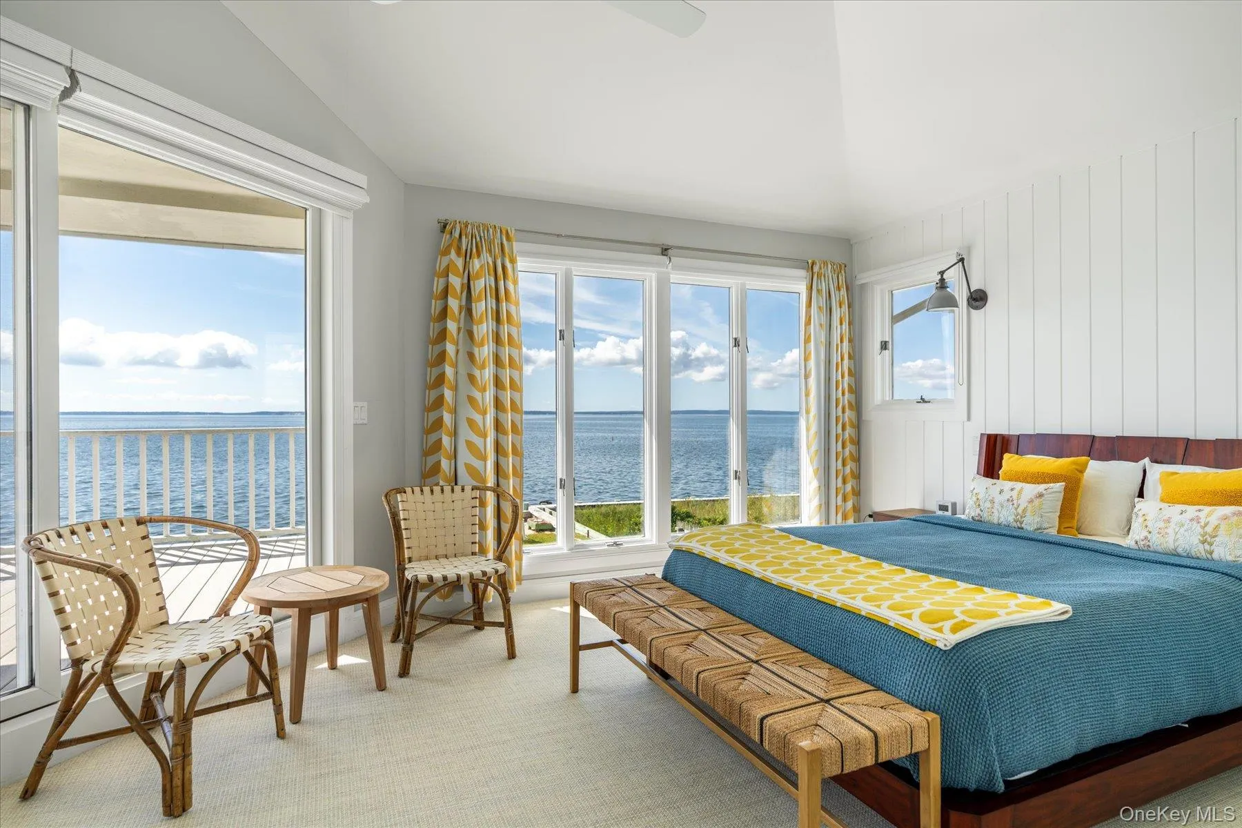 Serene primary suite with direct access to a private balcony overlooking the bay. Serene primary suite with direct access to a private balcony overlooking the bay.