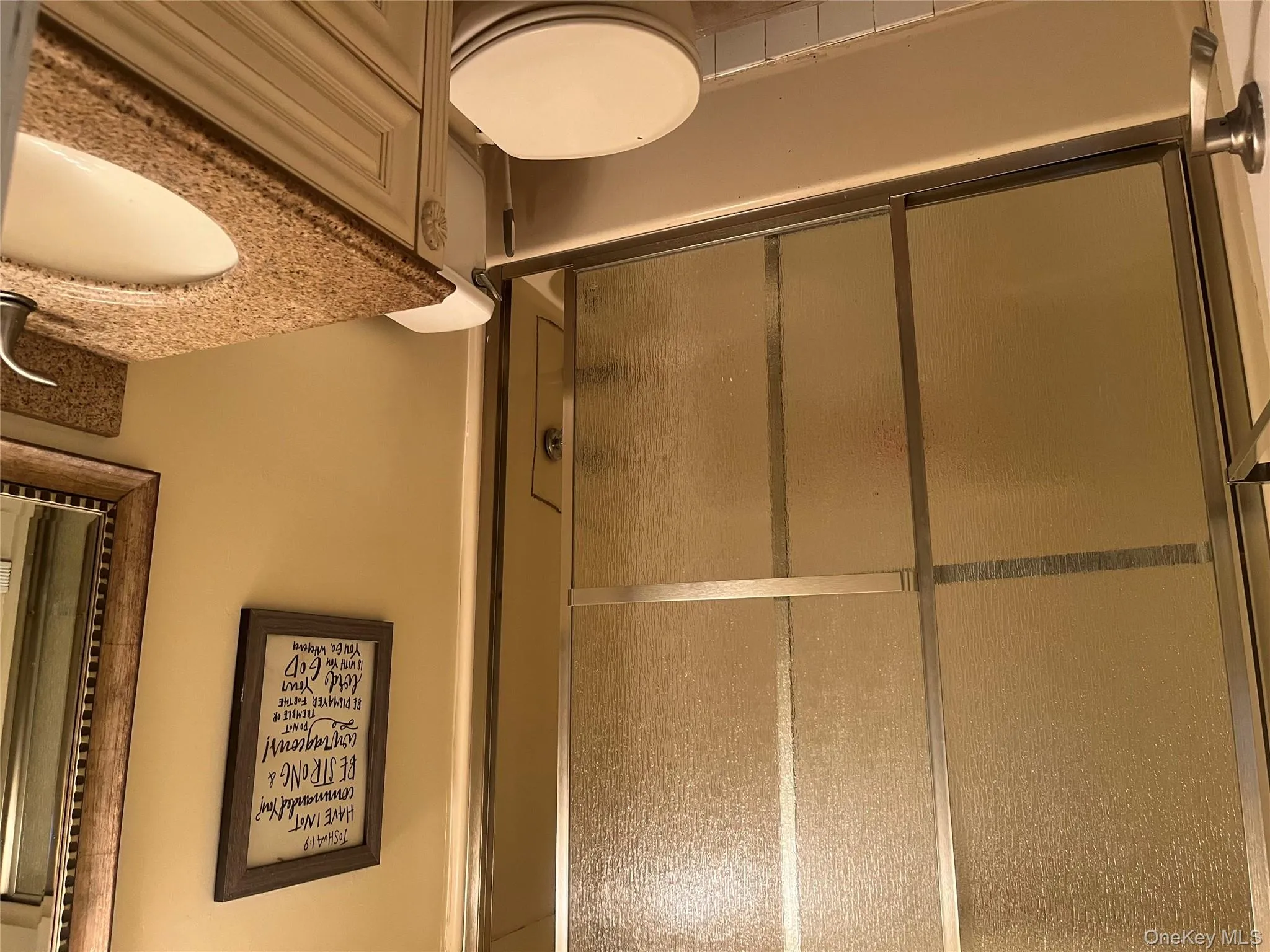 Bathroom featuring vanity and enclosed tub / shower combo Bathroom featuring vanity and enclosed tub / shower combo