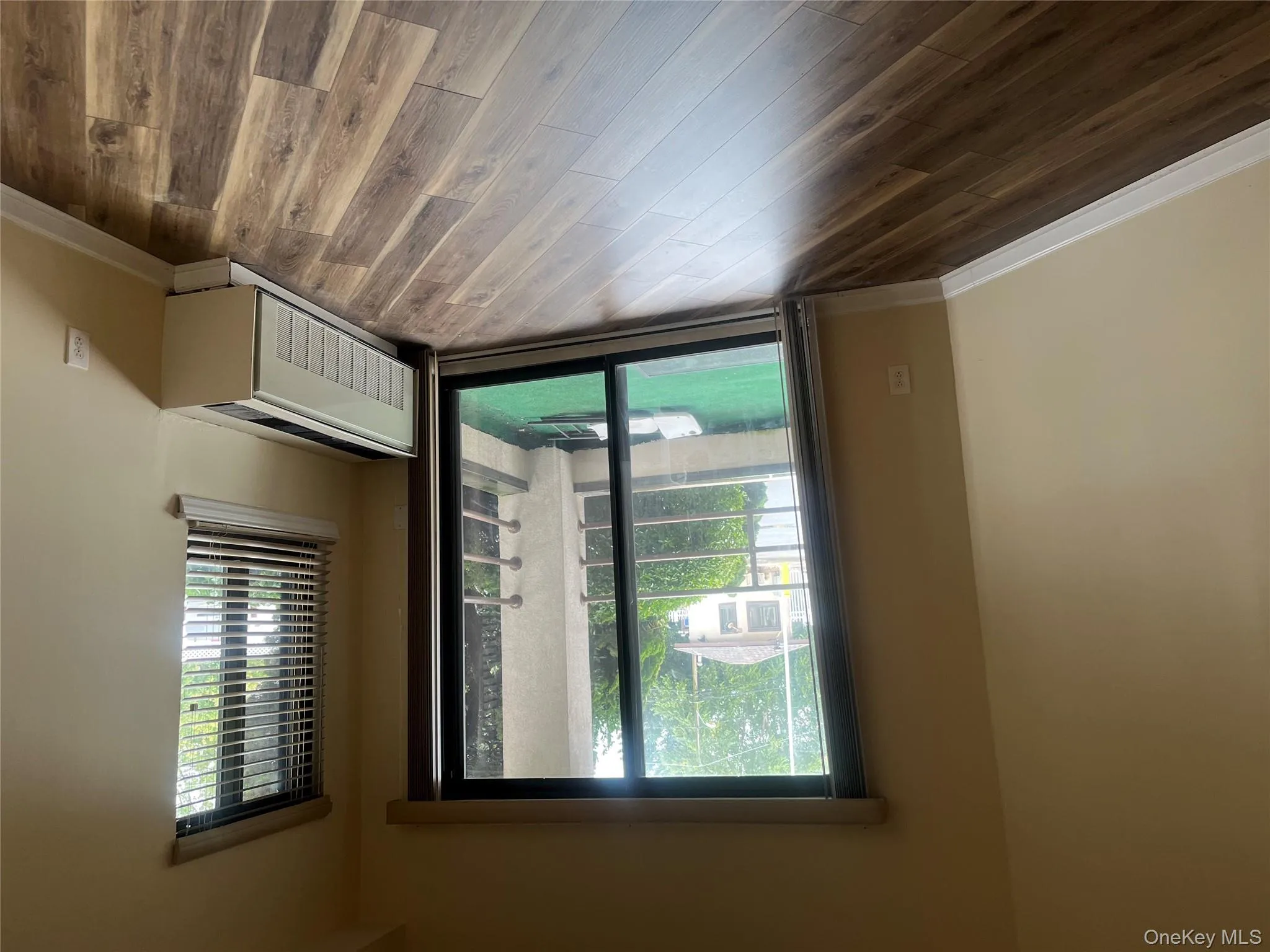 Empty room featuring radiator and dark wood-style flooring Empty room featuring radiator and dark wood-style flooring