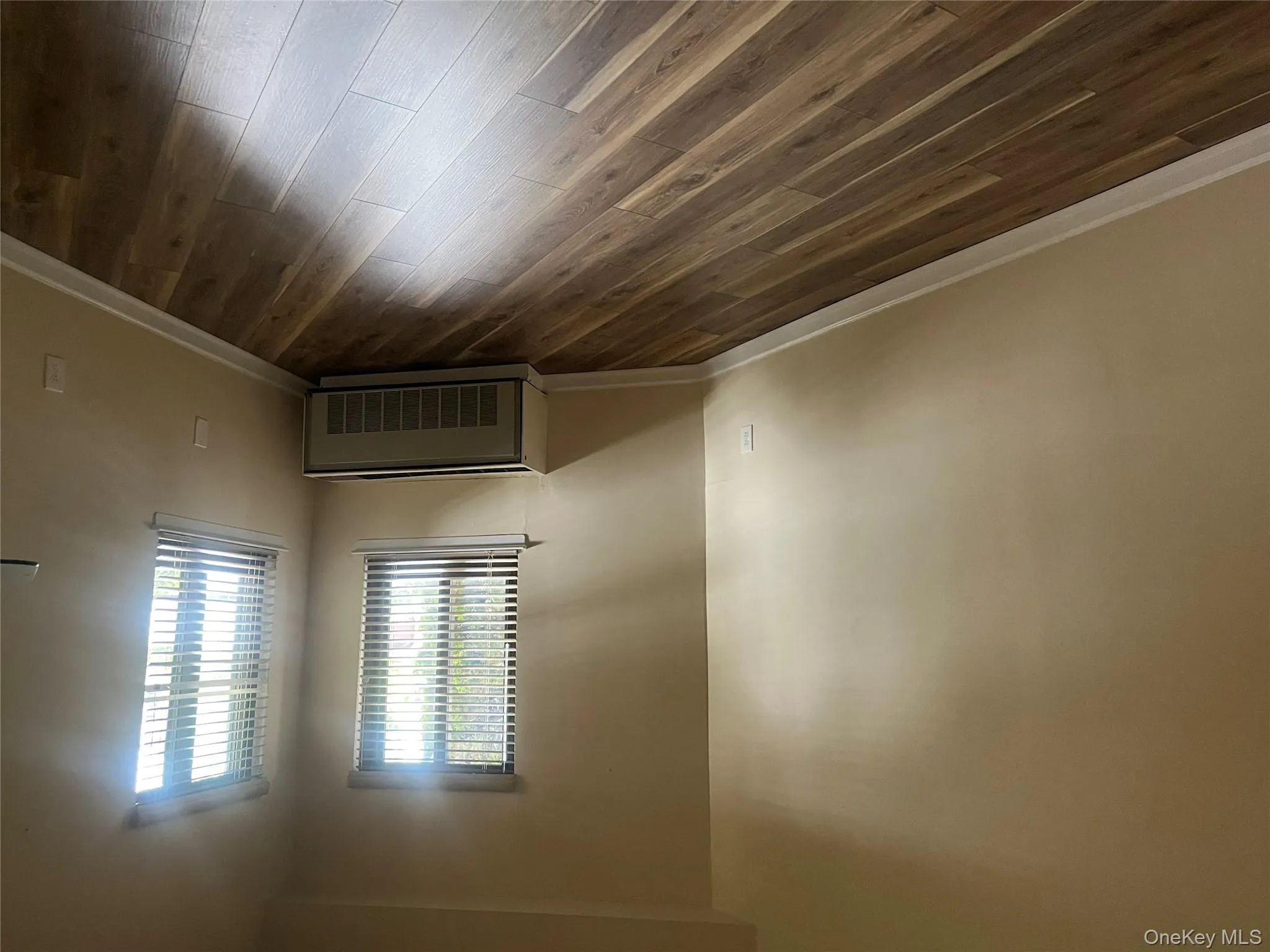 Unfurnished room featuring radiator and dark wood-style floors Unfurnished room featuring radiator and dark wood-style floors