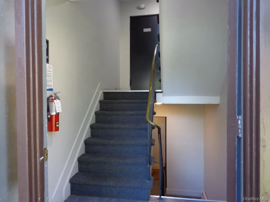 Staircase featuring baseboards Staircase featuring baseboards