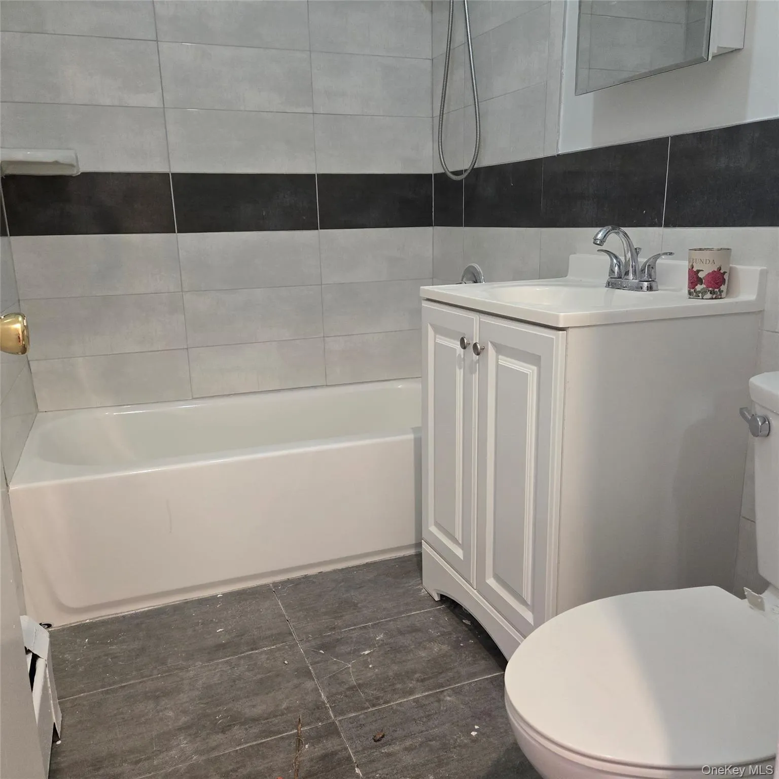 Full bathroom with vanity, washtub / shower combination, and tile walls Full bathroom with vanity, washtub / shower combination, and tile walls
