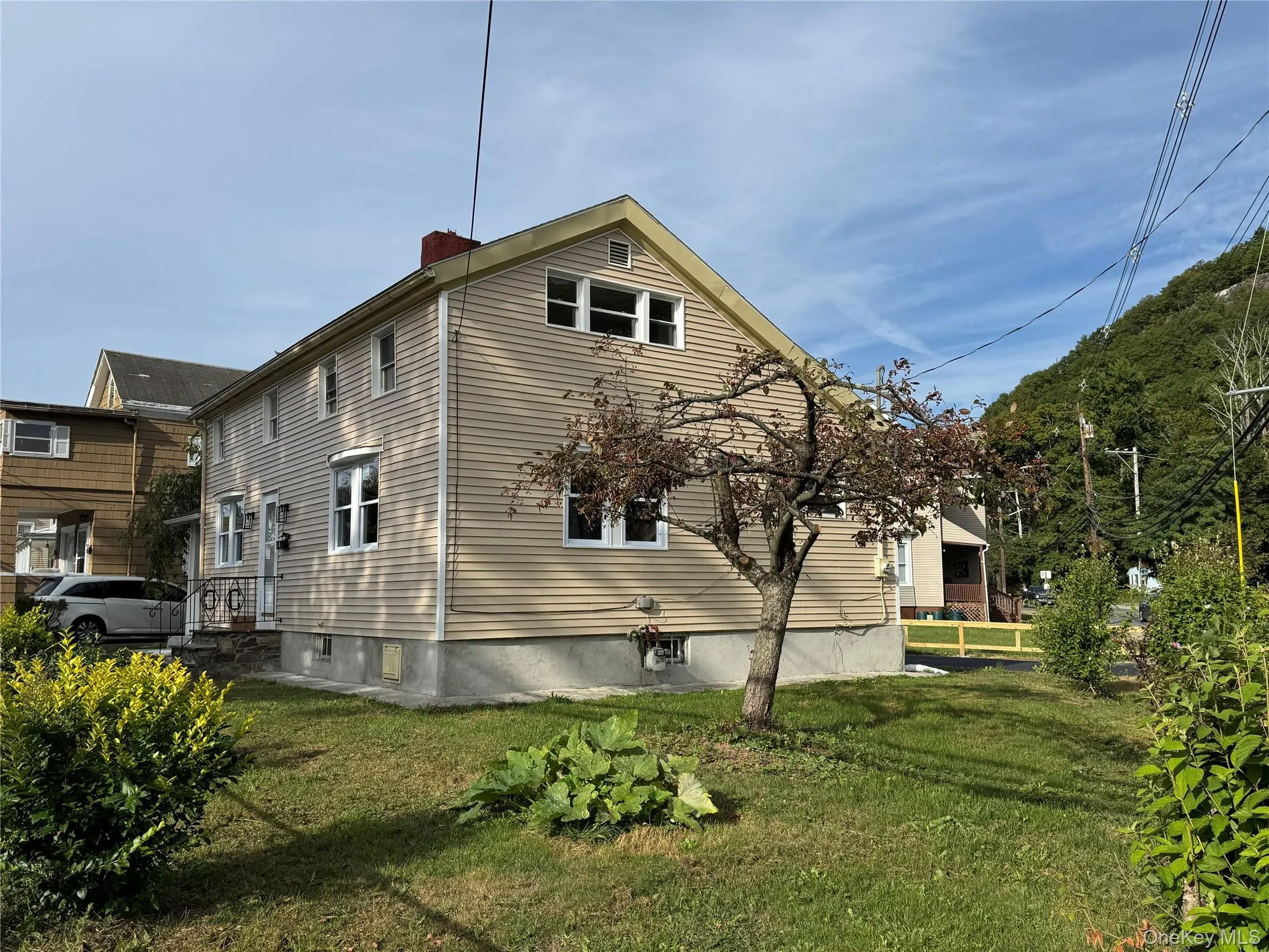 View of property exterior featuring a chimney and a yard View of property exterior featuring a chimney and a yard