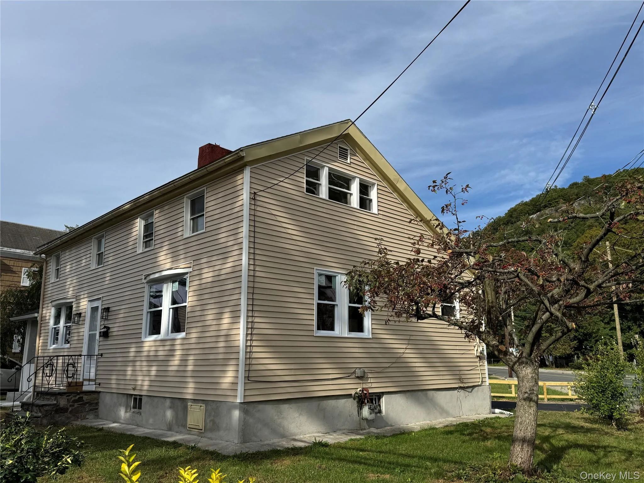 View of property exterior with a chimney and a yard View of property exterior with a chimney and a yard