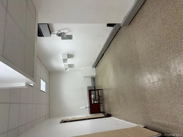 Basement with light floors and a paneled ceiling Basement with light floors and a paneled ceiling