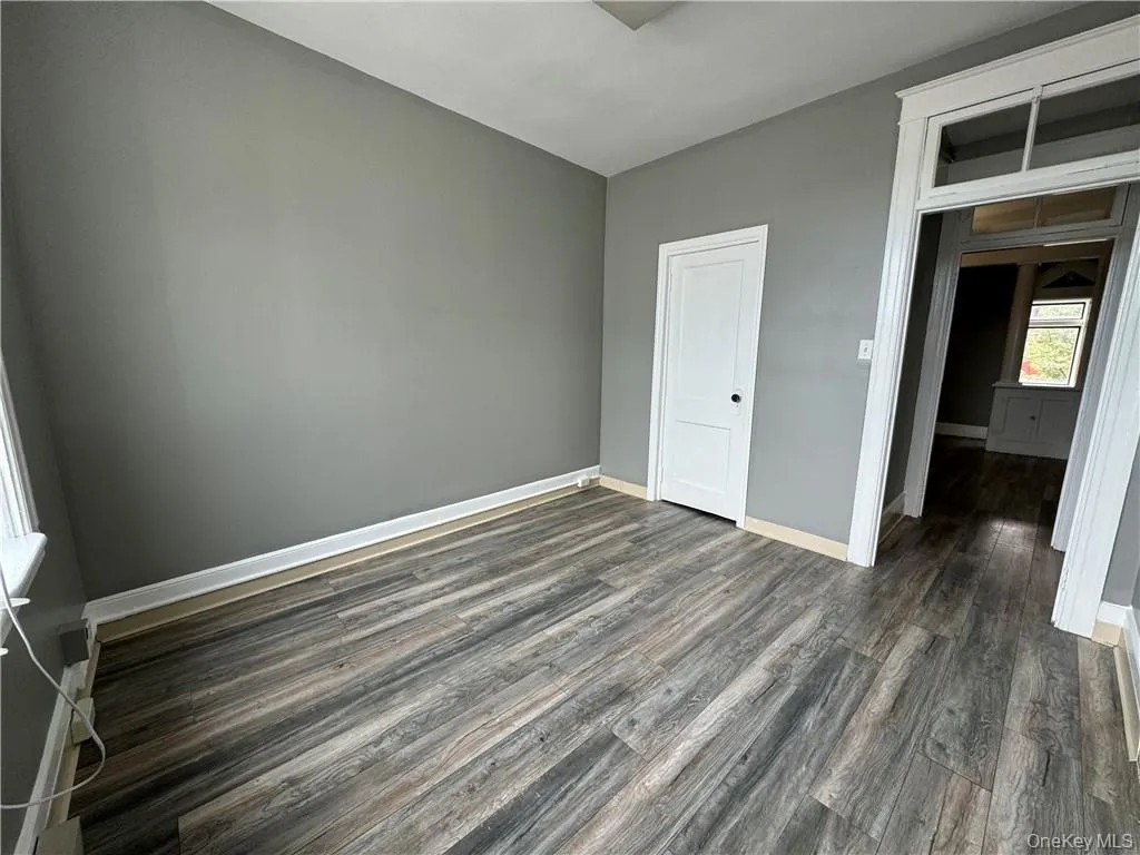 Unfurnished bedroom featuring a closet and dark hardwood / wood-style floors Unfurnished bedroom featuring a closet and dark hardwood / wood-style floors