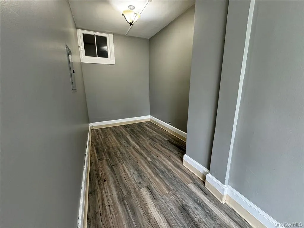 Unfurnished room featuring wood-type flooring Unfurnished room featuring wood-type flooring