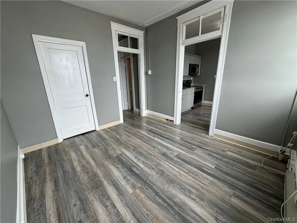 Unfurnished bedroom featuring dark hardwood / wood-style floors Unfurnished bedroom featuring dark hardwood / wood-style floors