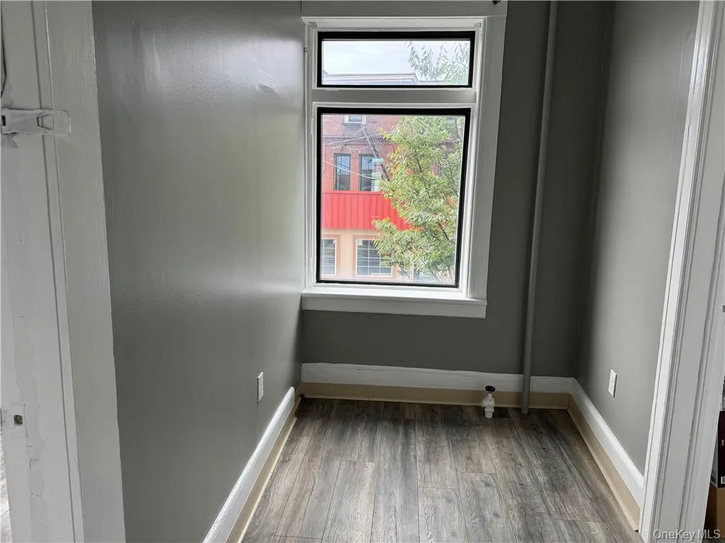Unfurnished room featuring dark wood-type flooring Unfurnished room featuring dark wood-type flooring