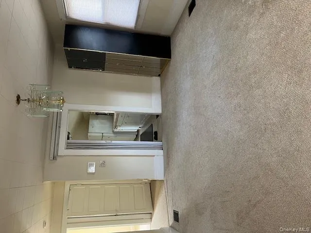 Unfurnished dining area with light colored carpet and a chandelier Unfurnished dining area with light colored carpet and a chandelier