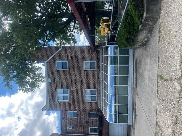 Rear view of property with brick siding and a chimney Rear view of property with brick siding and a chimney