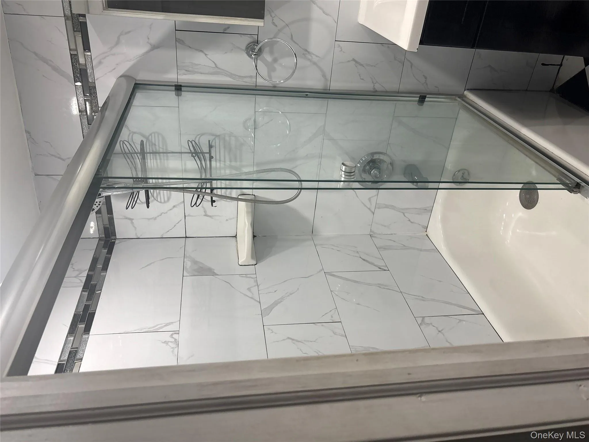 Full bath featuring bath / shower combo with glass door and vanity Full bath featuring bath / shower combo with glass door and vanity