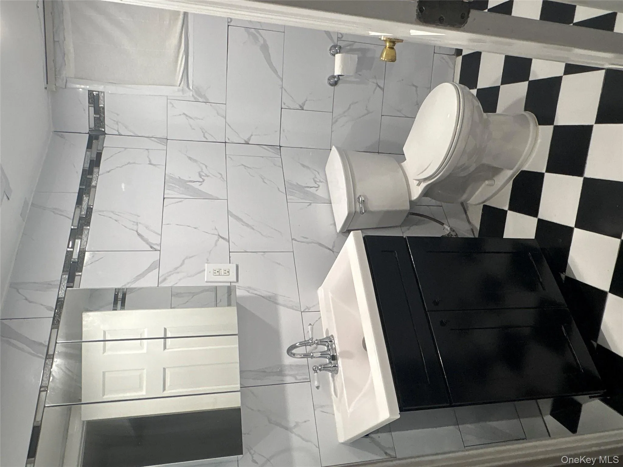 Half bathroom with tile walls, vanity, and light flooring Half bathroom with tile walls, vanity, and light flooring