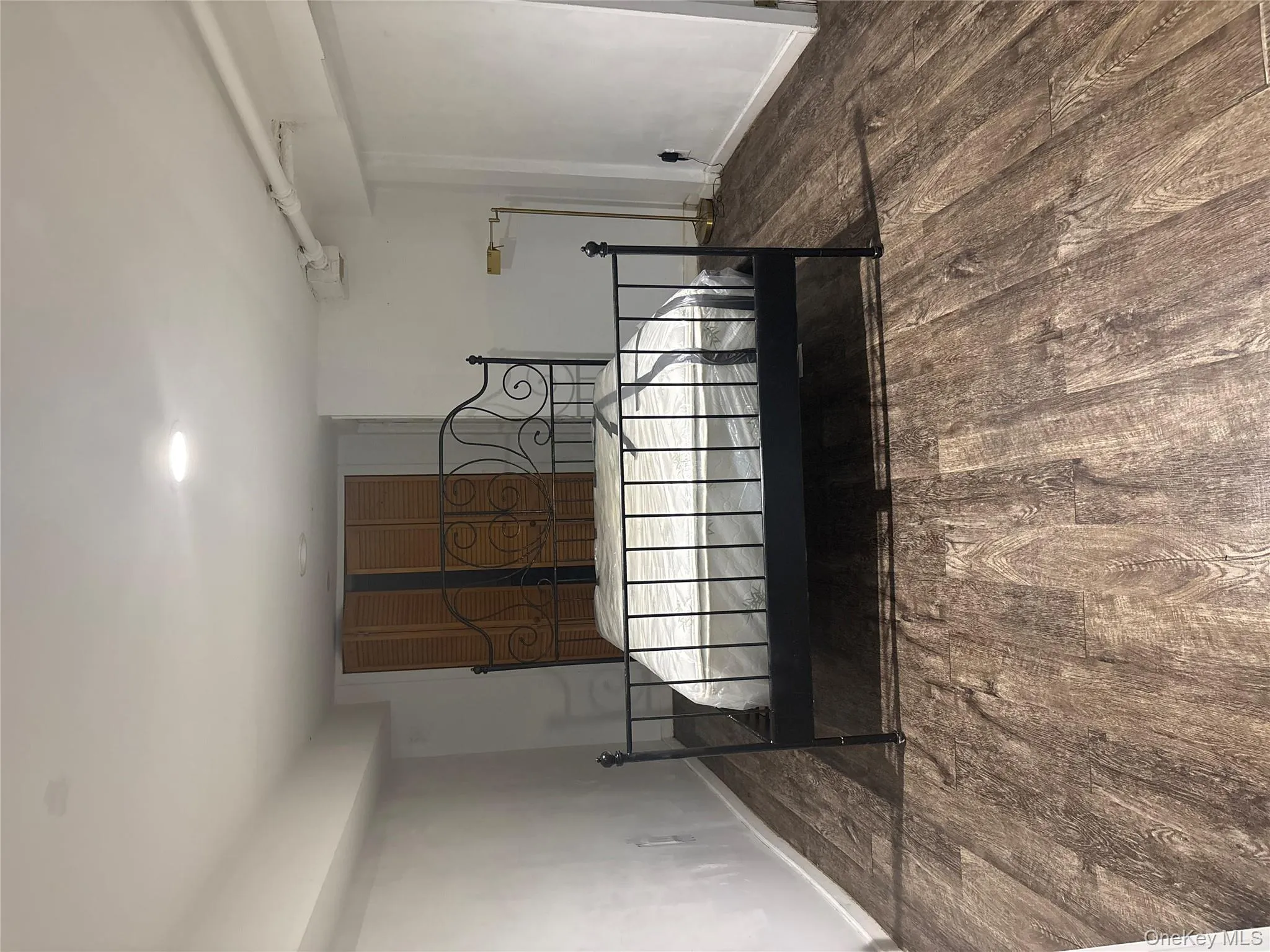 Bedroom featuring baseboards and dark wood-style floors Bedroom featuring baseboards and dark wood-style floors