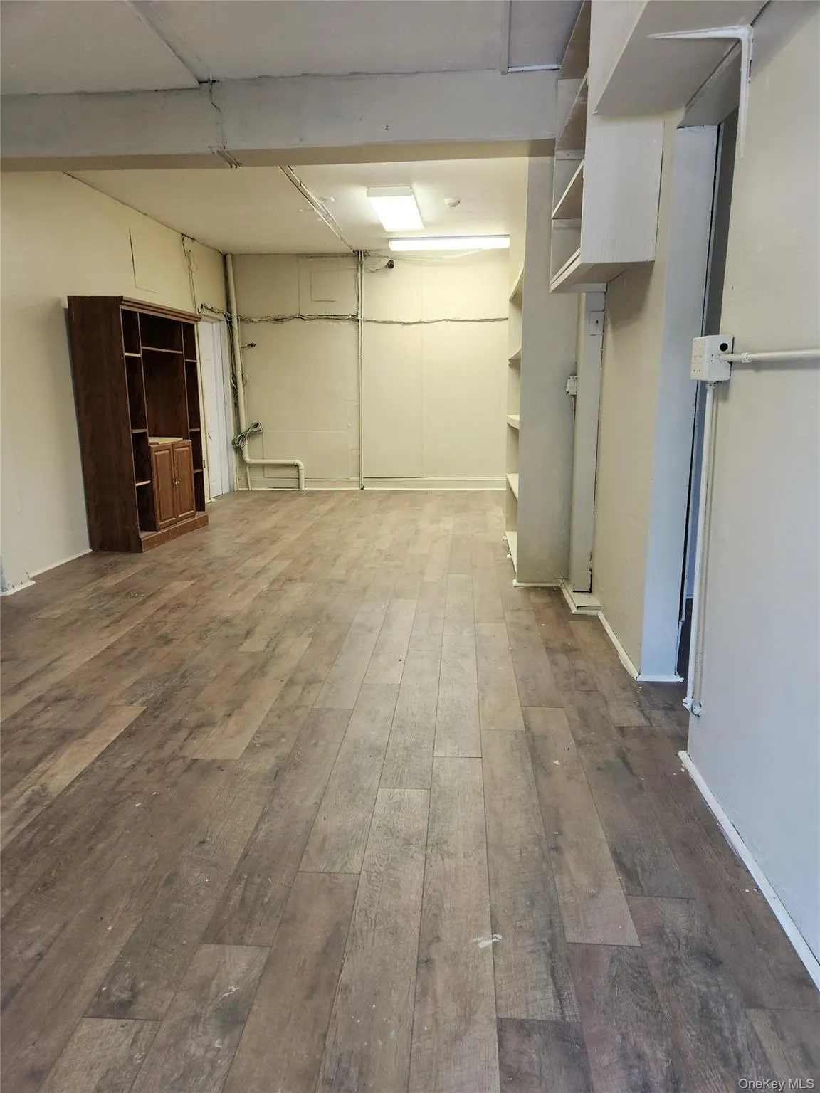 Below grade area featuring dark wood-type flooring and a garage Below grade area featuring dark wood-type flooring and a garage