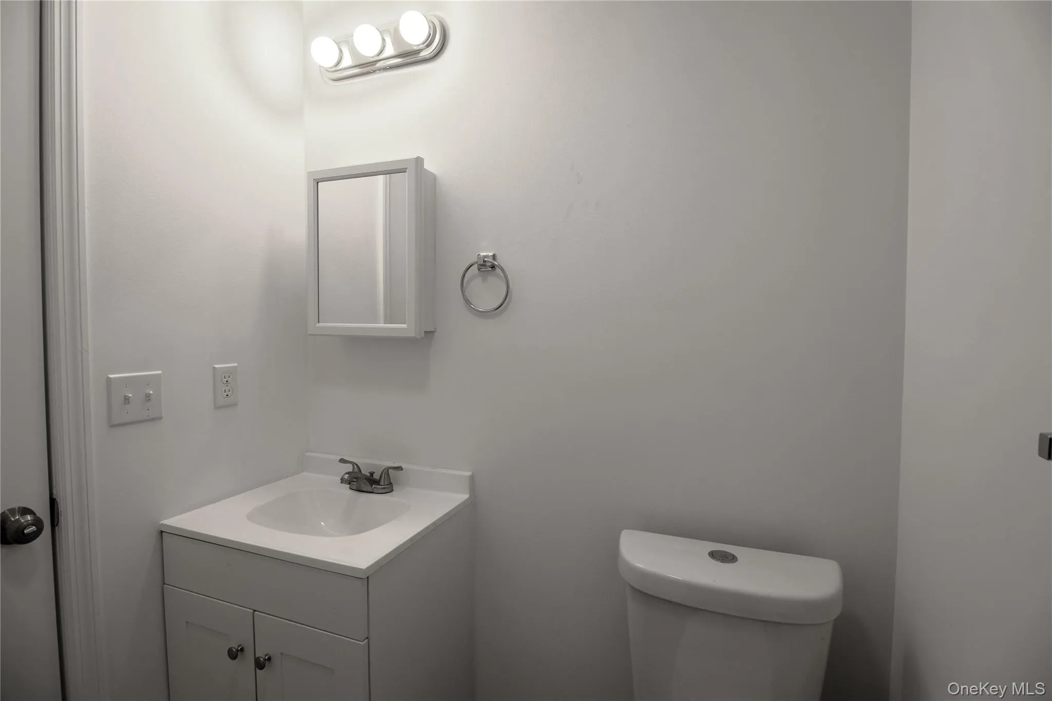 Half bathroom with vanity and toilet Half bathroom with vanity and toilet