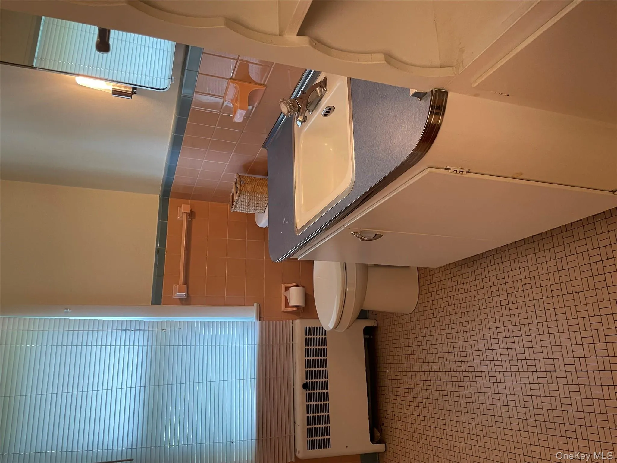 Bathroom featuring vanity, radiator heating unit, tile walls, and a wainscoted wall Bathroom featuring vanity, radiator heating unit, tile walls, and a wainscoted wall