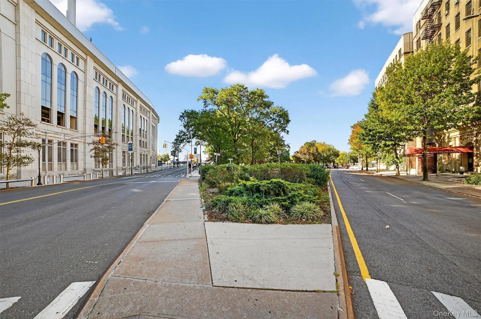 View of asphalt road with sidewalks, curbs, and street lighting View of asphalt road with sidewalks, curbs, and street lighting
