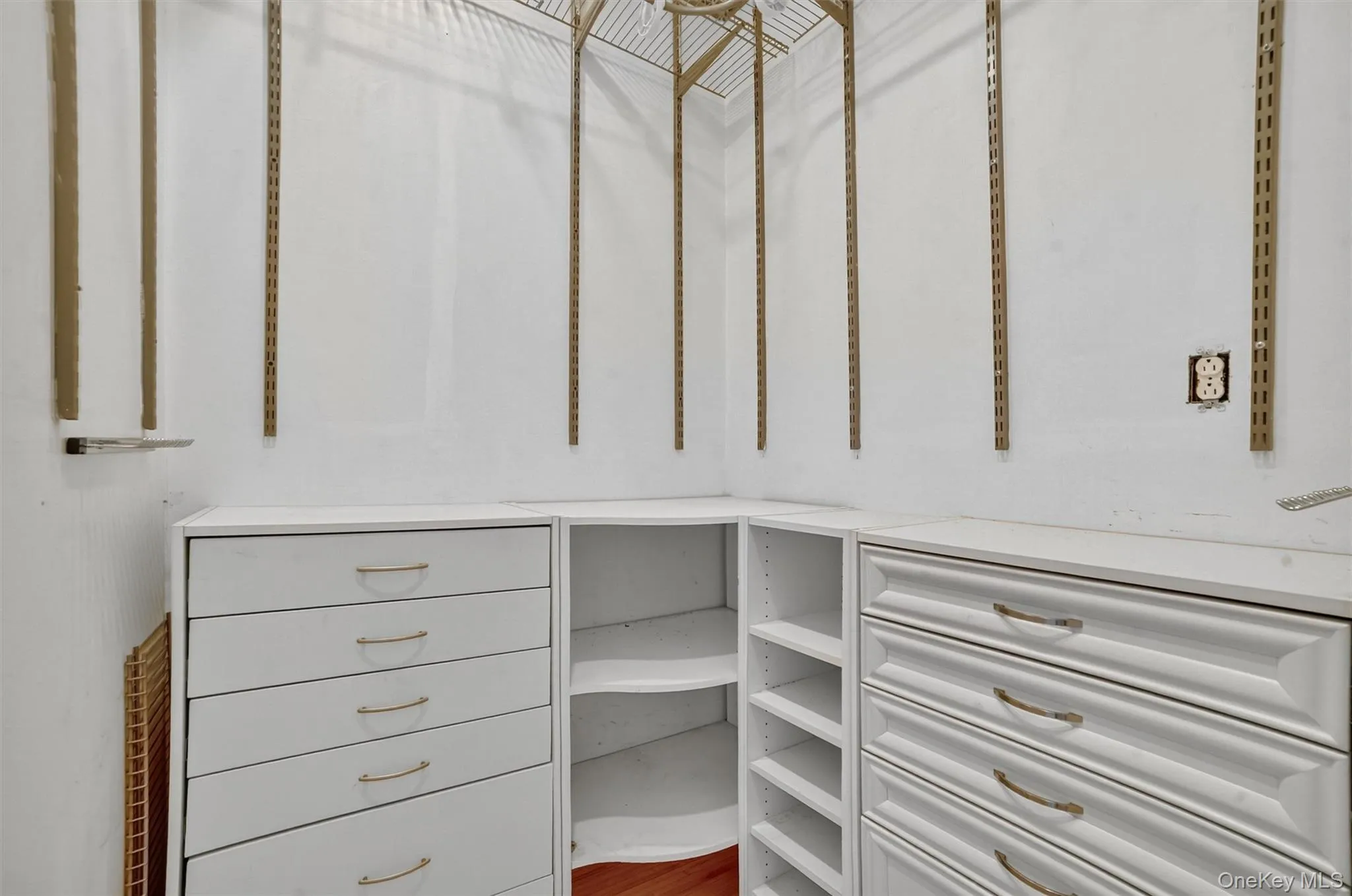 Walk in closet with wood finished floors Walk in closet with wood finished floors