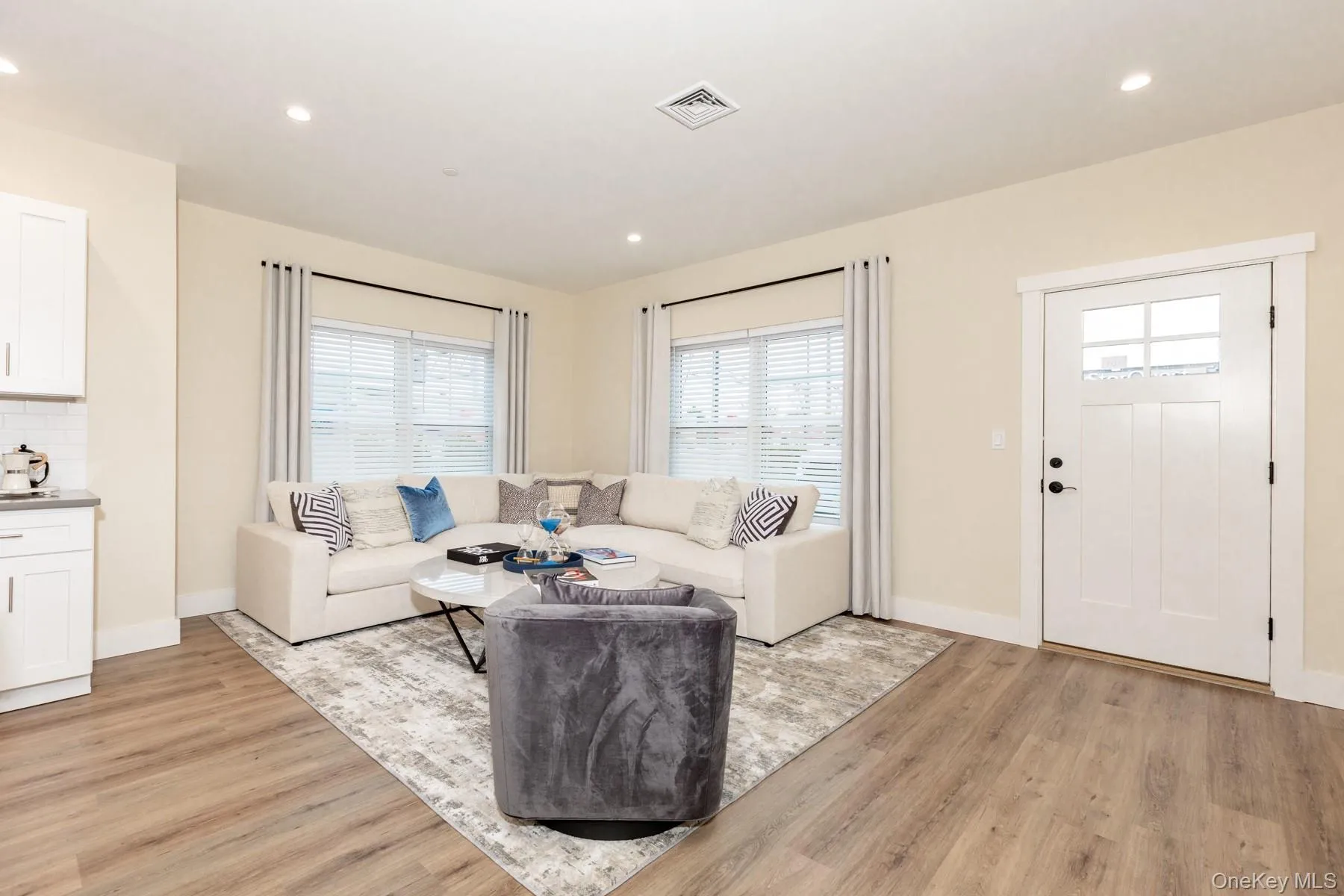 Living area with recessed lighting, plenty of natural light, and light wood-type flooring Living area with recessed lighting, plenty of natural light, and light wood-type flooring