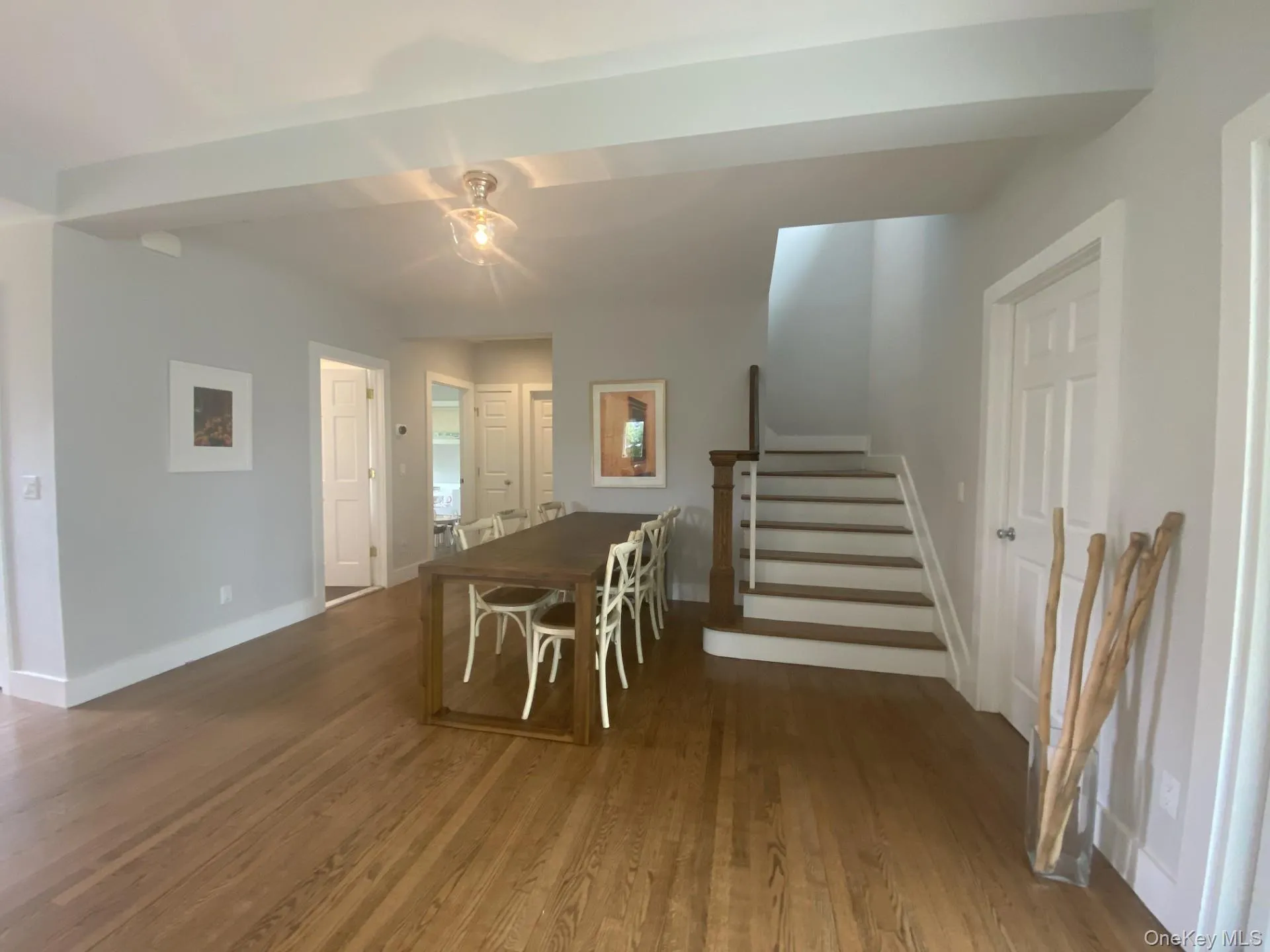 Dining room featuring stairs and wood finished floors Dining room featuring stairs and wood finished floors