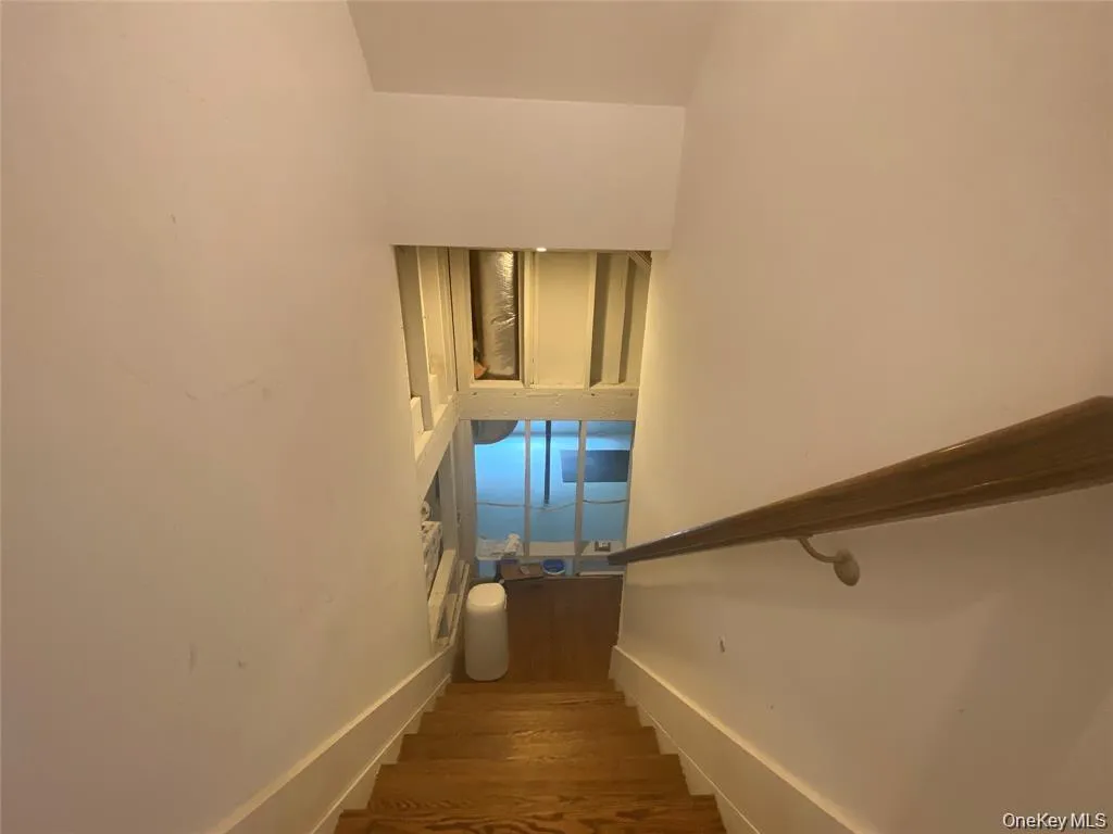 Stairway featuring wood finished floors Stairway featuring wood finished floors