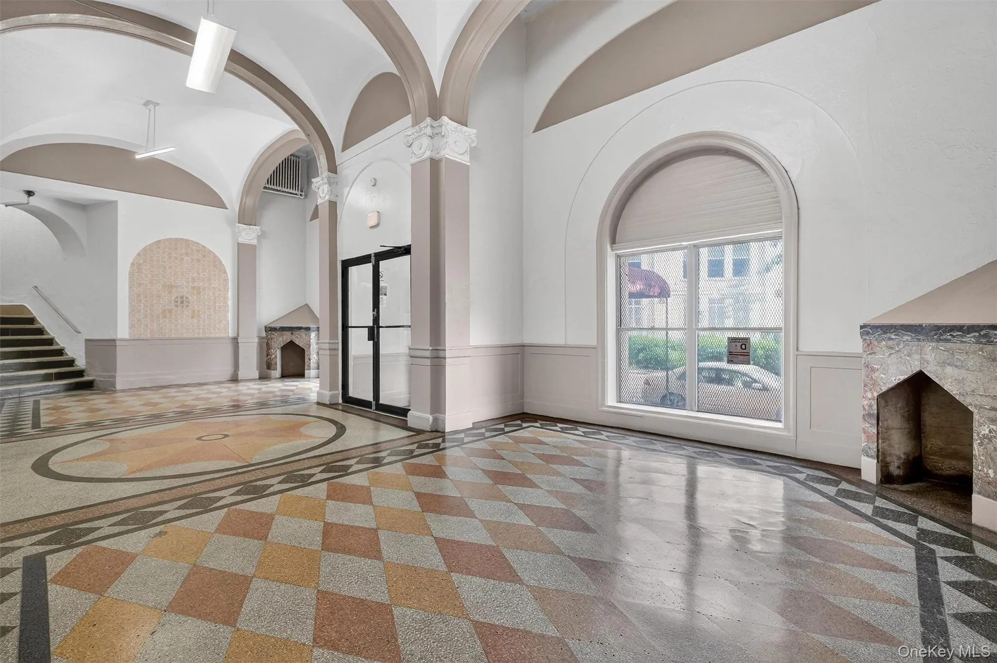Lobby with wainscoting and a high ceiling Lobby with wainscoting and a high ceiling