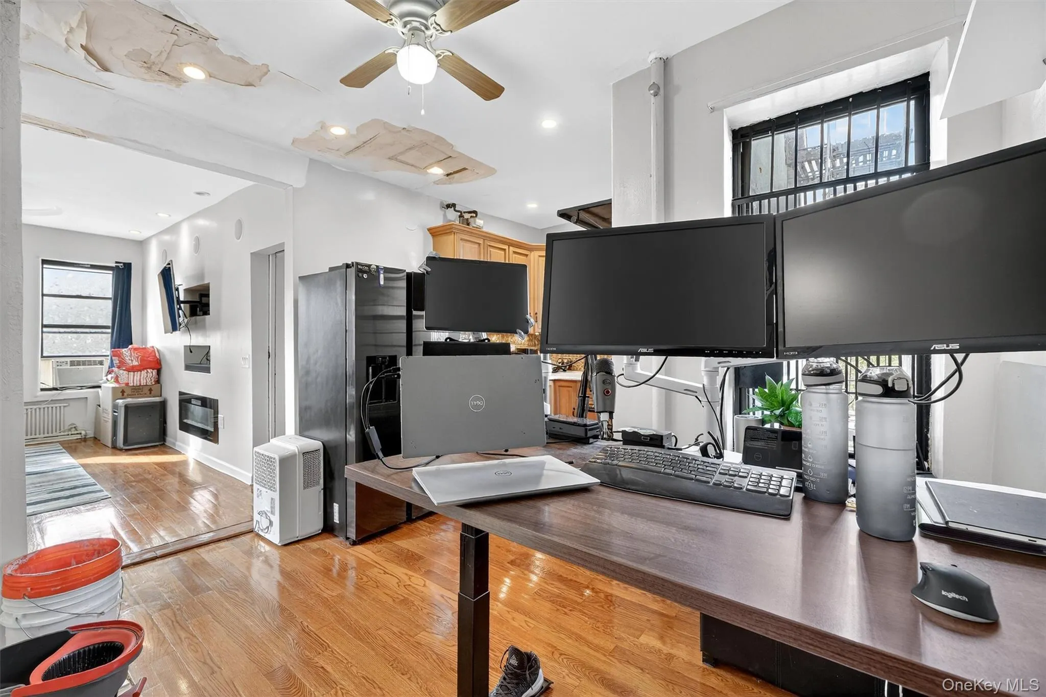 Home office with light wood-style flooring, ceiling fan, recessed lighting, and heating unit Home office with light wood-style flooring, ceiling fan, recessed lighting, and heating unit