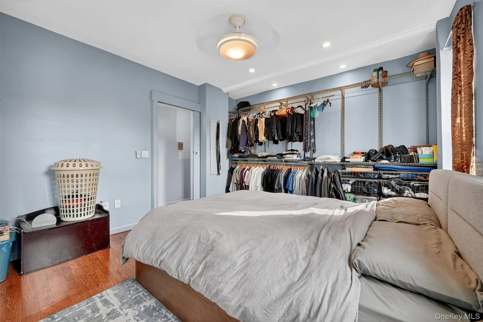 Bedroom featuring wood finished floors, recessed lighting, and a closet Bedroom featuring wood finished floors, recessed lighting, and a closet