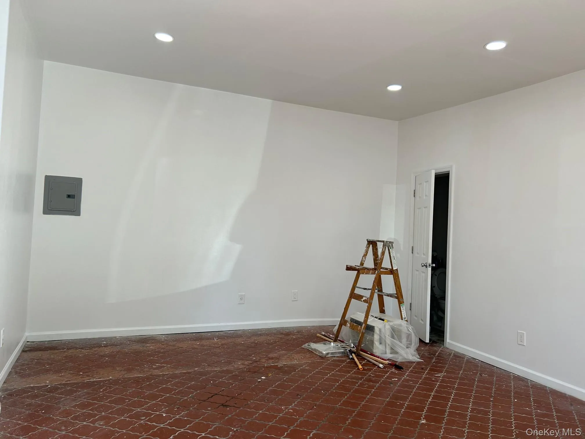 Empty room with recessed lighting and electric panel Empty room with recessed lighting and electric panel