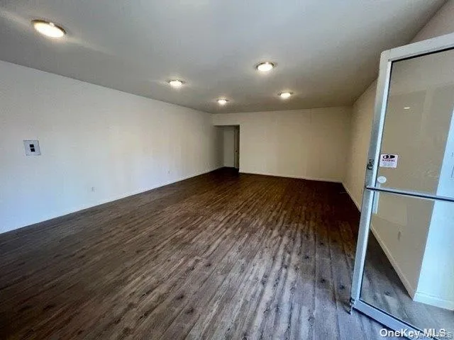Spare room with dark wood-style flooring Spare room with dark wood-style flooring
