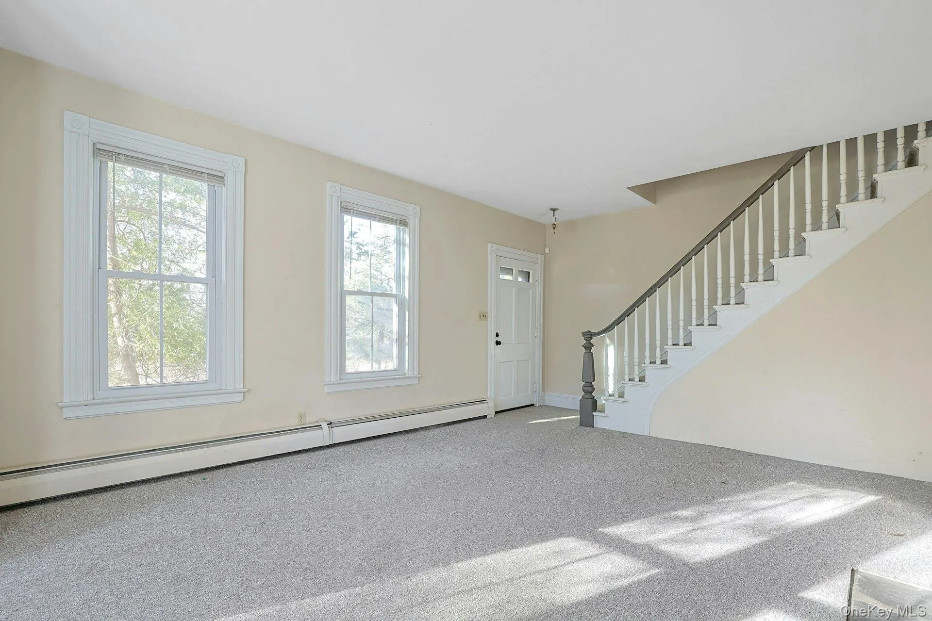 Front living room w stairs to upper level Front living room w stairs to upper level