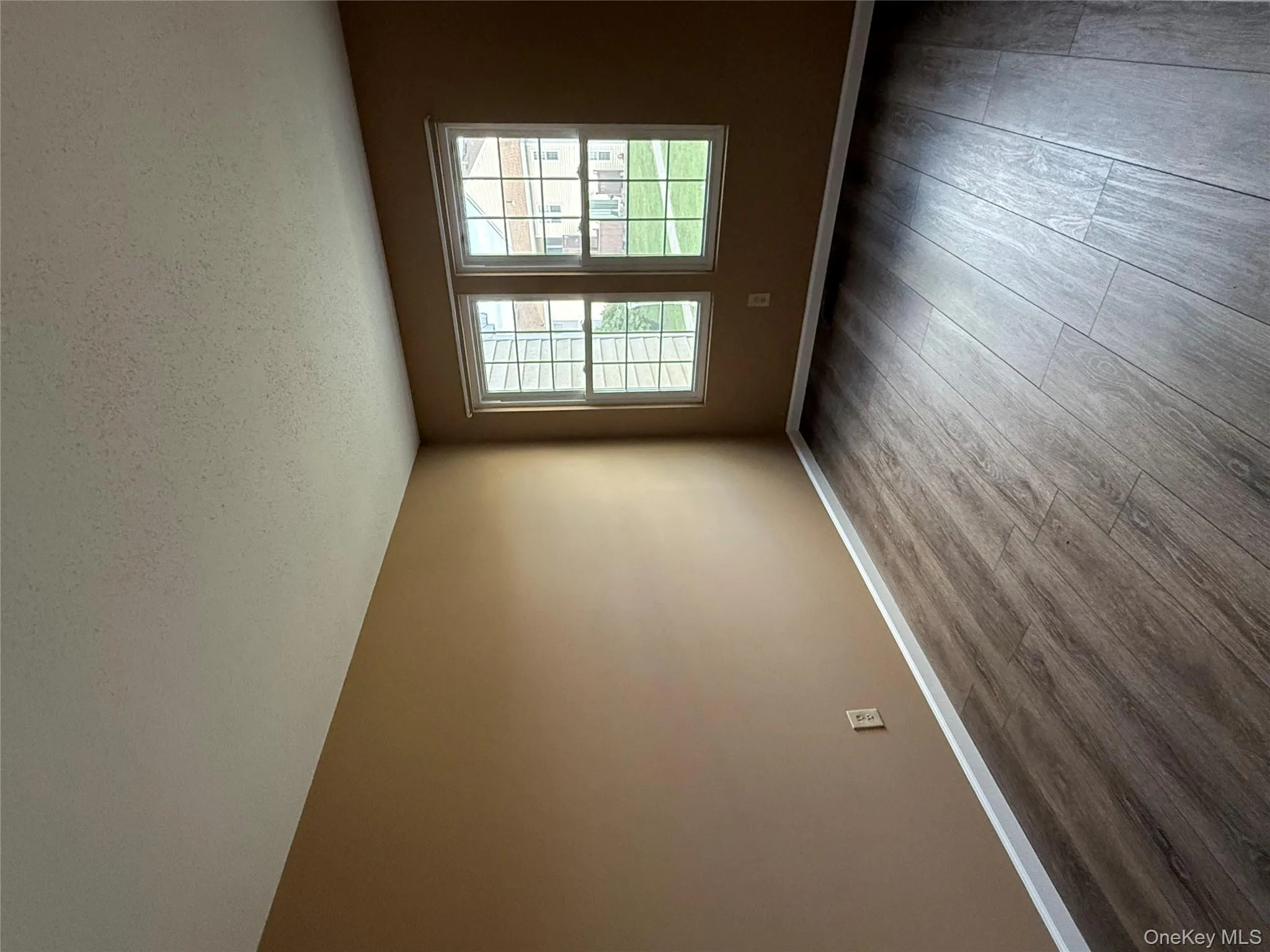 Empty room featuring dark wood-type flooring and a textured ceiling Empty room featuring dark wood-type flooring and a textured ceiling