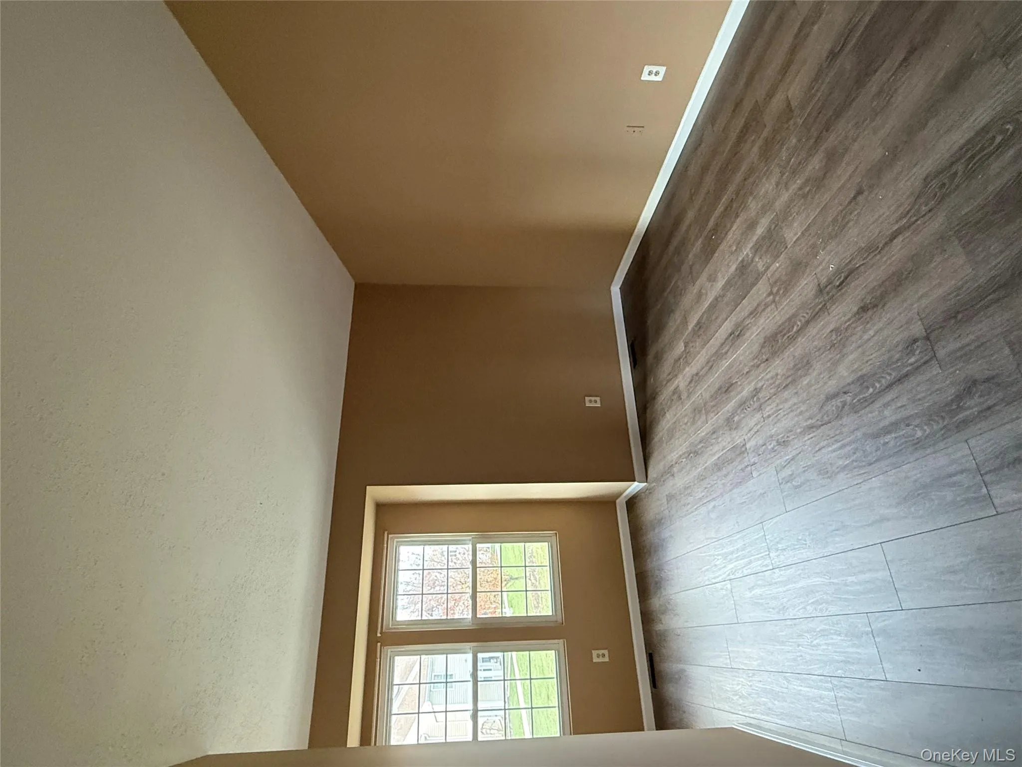 Spare room with wood finished floors and a textured ceiling Spare room with wood finished floors and a textured ceiling