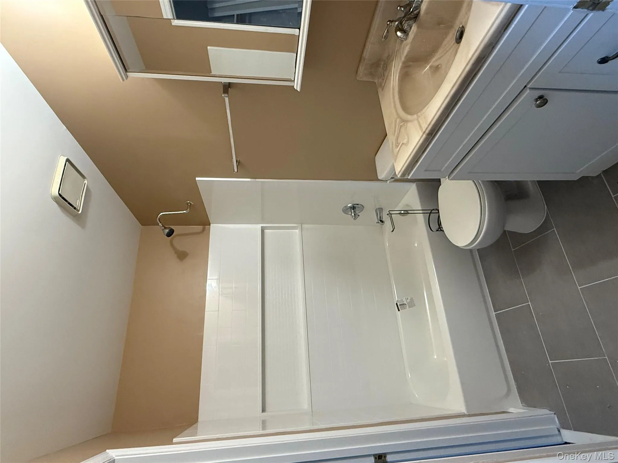 Full bathroom featuring dark tile patterned flooring, shower combination, and vanity Full bathroom featuring dark tile patterned flooring, shower combination, and vanity