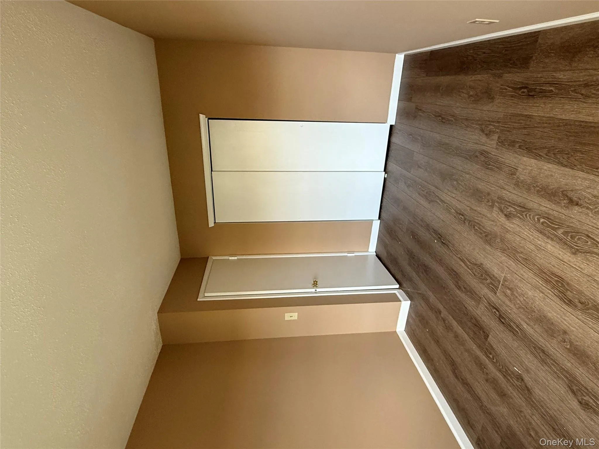 Unfurnished bedroom with a textured ceiling, a closet, and wood finished floors Unfurnished bedroom with a textured ceiling, a closet, and wood finished floors