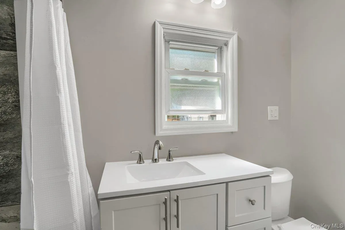 Full bath featuring vanity and a shower with curtain Full bath featuring vanity and a shower with curtain
