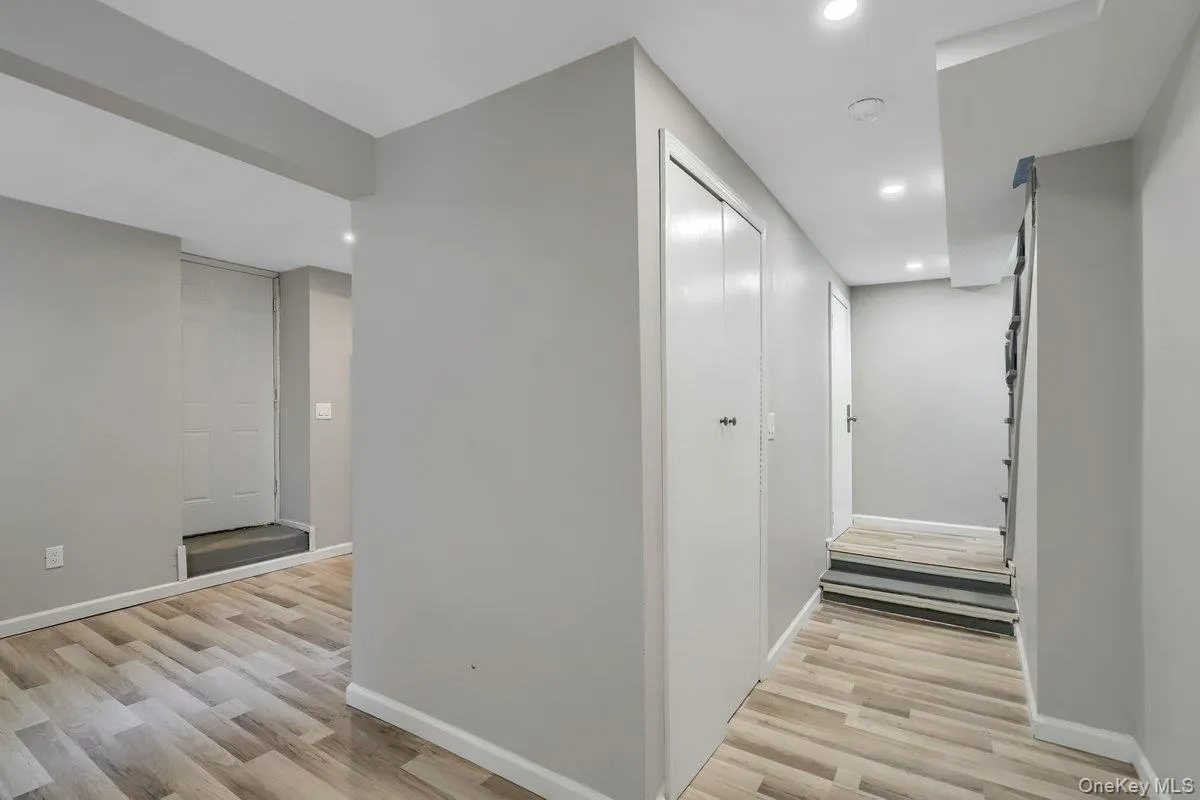 Corridor featuring recessed lighting and light wood finished floors Corridor featuring recessed lighting and light wood finished floors