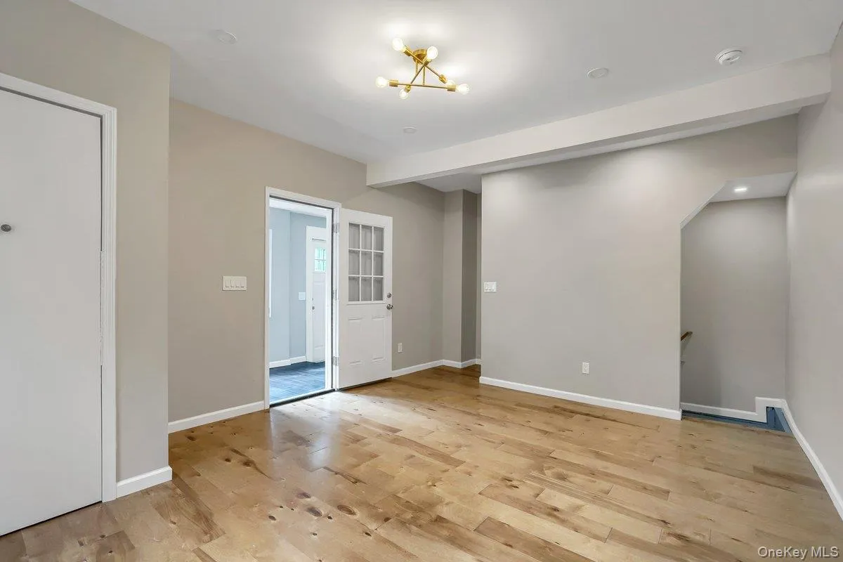 Spare room featuring light wood-type flooring, recessed lighting, and a chandelier Spare room featuring light wood-type flooring, recessed lighting, and a chandelier