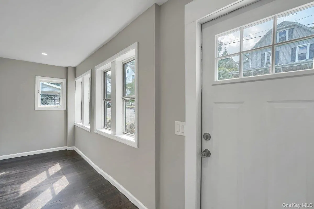 Entrance foyer with baseboards and dark wood-type flooring Entrance foyer with baseboards and dark wood-type flooring