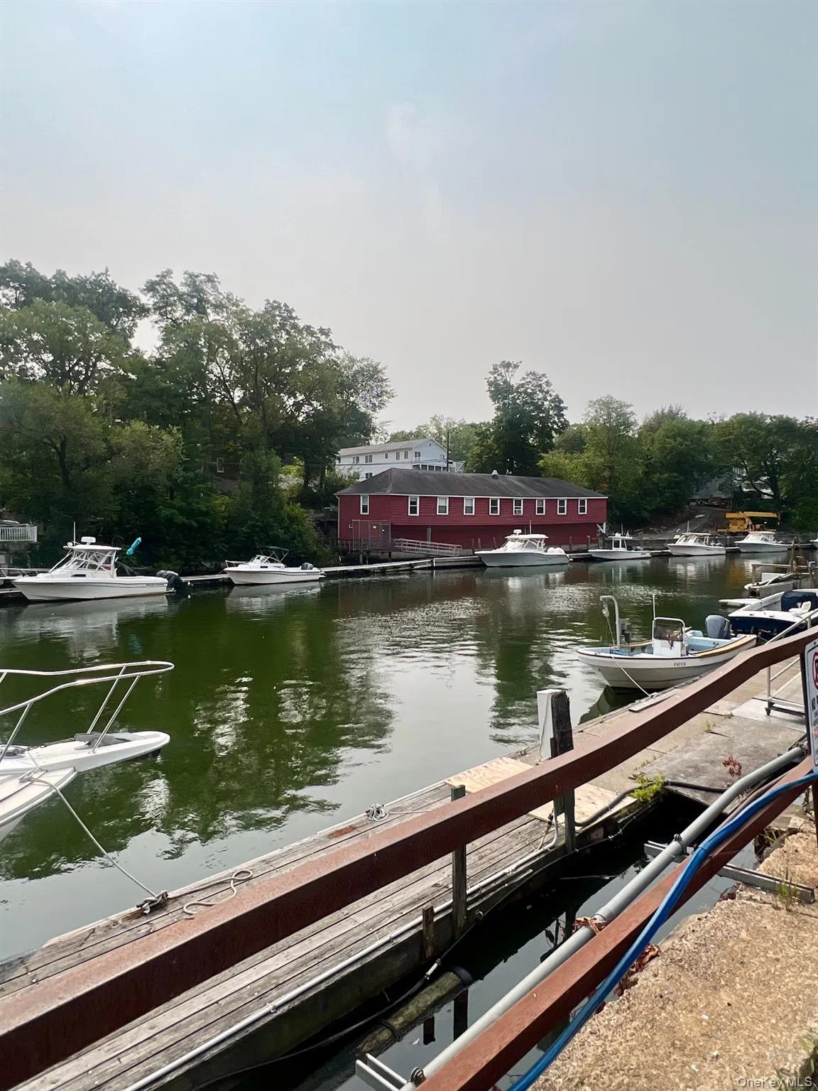 Dock area featuring a water view and view of scattered trees Dock area featuring a water view and view of scattered trees
